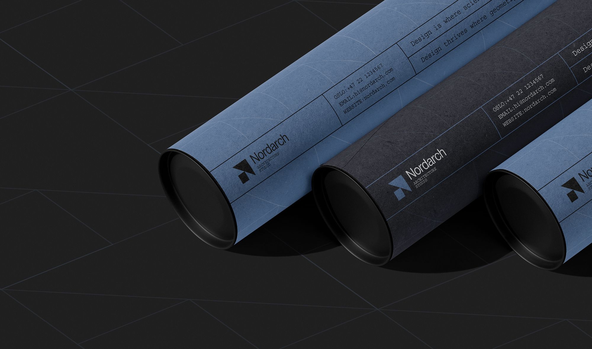 Nordarch branded drawing tubes in blue and black on a dark surface.